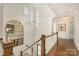 Bright hallway featuring hardwood floors, chandelier, grand staircase, and large picture window at 1328 S Kings Dr, Charlotte, NC 28207