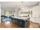Open concept kitchen with large island, marble countertops, pendant lighting and view to the dining area at 1328 S Kings Dr, Charlotte, NC 28207