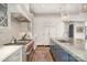 Chef's kitchen with stainless steel appliances, custom cabinetry, and large island with marble countertops at 1328 S Kings Dr, Charlotte, NC 28207