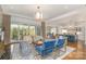 Open-concept living room with hardwood floors, modern furniture, and large sliding glass doors at 1328 S Kings Dr, Charlotte, NC 28207