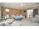 Inviting living room with plush seating, ceiling fan, neutral decor, and access to a staircase at 1328 S Kings Dr, Charlotte, NC 28207
