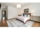 Bright main bedroom with a large bed, neutral colors, and hardwood floors at 1328 S Kings Dr, Charlotte, NC 28207