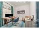 Bright home office with a large window, wood desk, modern decor, and a comfortable chair at 1328 S Kings Dr, Charlotte, NC 28207