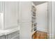 Walk-in pantry with custom shelves and storage solutions, offering ample space for kitchen essentials at 1328 S Kings Dr, Charlotte, NC 28207