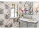 Chic powder room featuring butterfly wallpaper, marble vanity, and decorative mirror at 1328 S Kings Dr, Charlotte, NC 28207