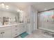 This modern bathroom boasts double sinks, ample vanity storage, sleek fixtures, and a glass-enclosed shower at 1348 Southern Sugar Dr, Charlotte, NC 28262