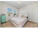 A cozy bedroom has neutral walls, carpet flooring and a large window bringing in natural light at 1348 Southern Sugar Dr, Charlotte, NC 28262