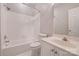 Bright bathroom with white tiled walls, featuring a tub and shower combination, and a vanity sink at 14106 Yachtsman Harbor Dr, Charlotte, NC 28278