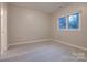 Bright bedroom with neutral walls and carpet, a window, and closet for a clean and modern aesthetic at 14106 Yachtsman Harbor Dr, Charlotte, NC 28278