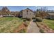 Townhouse with lawn and walkway, surrounded by trees and shrubbery, located near the lake at 14106 Yachtsman Harbor Dr, Charlotte, NC 28278