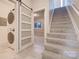 Hallway with laundry area and frosted glass door leading to carpeted stairs at 14106 Yachtsman Harbor Dr, Charlotte, NC 28278