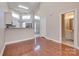 Bright living room with hardwood floors leading to an open kitchen and bathroom at 14106 Yachtsman Harbor Dr, Charlotte, NC 28278