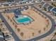Aerial view of a community pool with lounge chairs and clubhouse surrounded by homes and streets at 146 Stibbs Cross Rd, Mooresville, NC 28115