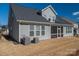 Backyard exterior of a two-story home with a screened-in porch and air conditioning units at 146 Stibbs Cross Rd, Mooresville, NC 28115