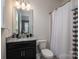 Bathroom with granite vanity, neutral walls, toilet, and shower with curtain at 146 Stibbs Cross Rd, Mooresville, NC 28115