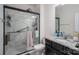 Modern bathroom showcasing a marble tiled shower and vanity with granite counter at 146 Stibbs Cross Rd, Mooresville, NC 28115