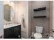 Powder room with pedestal sink, round mirror and shelving at 146 Stibbs Cross Rd, Mooresville, NC 28115