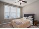 Bedroom with large windows, neutral walls, ceiling fan and bed with decorative pillows at 146 Stibbs Cross Rd, Mooresville, NC 28115
