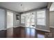 Dining area with hardwood floors, a modern chandelier, and sliding glass doors leading to an outdoor space at 146 Stibbs Cross Rd, Mooresville, NC 28115
