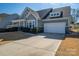 Charming two story home with a two car garage, dormer windows and a landscaped front yard at 146 Stibbs Cross Rd, Mooresville, NC 28115