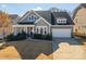 Charming two-story home featuring gray siding, stone accents, well-maintained landscaping, and an attached two-car garage at 146 Stibbs Cross Rd, Mooresville, NC 28115