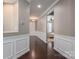 Hallway featuring hardwood floors, white trim, neutral walls, and views of the entryway and another room at 146 Stibbs Cross Rd, Mooresville, NC 28115