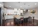 Kitchen featuring a large island with bar seating, granite countertops, white cabinetry, and stainless steel appliances at 146 Stibbs Cross Rd, Mooresville, NC 28115