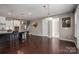 Open-concept living room showcasing hardwood floors, an elegant chandelier, and seamless access to the kitchen at 146 Stibbs Cross Rd, Mooresville, NC 28115