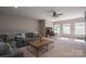 Spacious living room featuring a ceiling fan, a comfortable couch, and a desk at 146 Stibbs Cross Rd, Mooresville, NC 28115