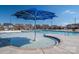 Large community pool featuring a splash pad and large blue umbrella for relaxing in the sun at 146 Stibbs Cross Rd, Mooresville, NC 28115