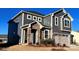 Charming two-story home with stone facade, gray siding, and attached two-car garage at 1463 Honey Trl, Monroe, NC 28112