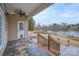 Back porch with fan overlooks lake and has steps to a small yard at 1750 Williamsburg Dr, Rock Hill, SC 29732