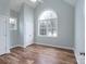 Bedroom with a large arch window, ceiling fan and wood floors at 1750 Williamsburg Dr, Rock Hill, SC 29732