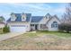 Charming two-story home with a well-manicured lawn and attached two-car garage at 1750 Williamsburg Dr, Rock Hill, SC 29732