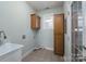 Laundry room with large utility sink, tile floors and storage cabinets at 1750 Williamsburg Dr, Rock Hill, SC 29732