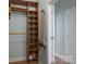 Walk-in closet with wooden storage and shelving, next to the ironing board at 1750 Williamsburg Dr, Rock Hill, SC 29732
