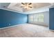 Spacious main bedroom with tray ceiling, fan, large windows, and neutral carpet at 1938 Mallard Pointe Dr, Kannapolis, NC 28083