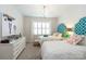 Bright bedroom with twin beds, white furniture, and cheerful decor accents at 2016 Thatcher Way, Fort Mill, SC 29715