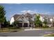 Elegant white brick home with a manicured front lawn, black fencing, and a convenient two-car garage at 2016 Thatcher Way, Fort Mill, SC 29715