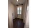 Light-filled hallway with wood floors, plantation shutters, and designer curtains at 2016 Thatcher Way, Fort Mill, SC 29715