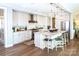 Modern kitchen with stainless steel appliances, white cabinetry, island with bar seating and pendant lighting at 2016 Thatcher Way, Fort Mill, SC 29715
