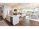 Open-concept kitchen and living space with large island, fireplace, and seamless access to the outdoors at 2016 Thatcher Way, Fort Mill, SC 29715