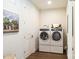 Well-lit laundry room with front-load washer and dryer and wood-look floors at 2016 Thatcher Way, Fort Mill, SC 29715