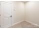 Small carpeted room with a door and neutral walls, great for storage or an office at 2016 Thatcher Way, Fort Mill, SC 29715