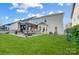Expansive backyard featuring a patio with an outdoor kitchen, fireplace, and seating at 2024 Woodshorn Dr, Matthews, NC 28104