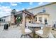 Spacious backyard patio with an outdoor kitchen, fireplace, and dining set at 2024 Woodshorn Dr, Matthews, NC 28104