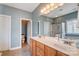Bathroom featuring double sinks with a large mirror and a separate toilet room at 2024 Woodshorn Dr, Matthews, NC 28104