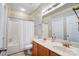 Bathroom featuring double sinks with cabinets and a shower/tub with a white curtain at 2024 Woodshorn Dr, Matthews, NC 28104