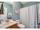 Cozy bathroom featuring a vanity with wooden cabinets and a shower with curtain at 2024 Woodshorn Dr, Matthews, NC 28104