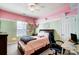 Bedroom featuring a bed, a computer desk, and pink and green walls at 2024 Woodshorn Dr, Matthews, NC 28104